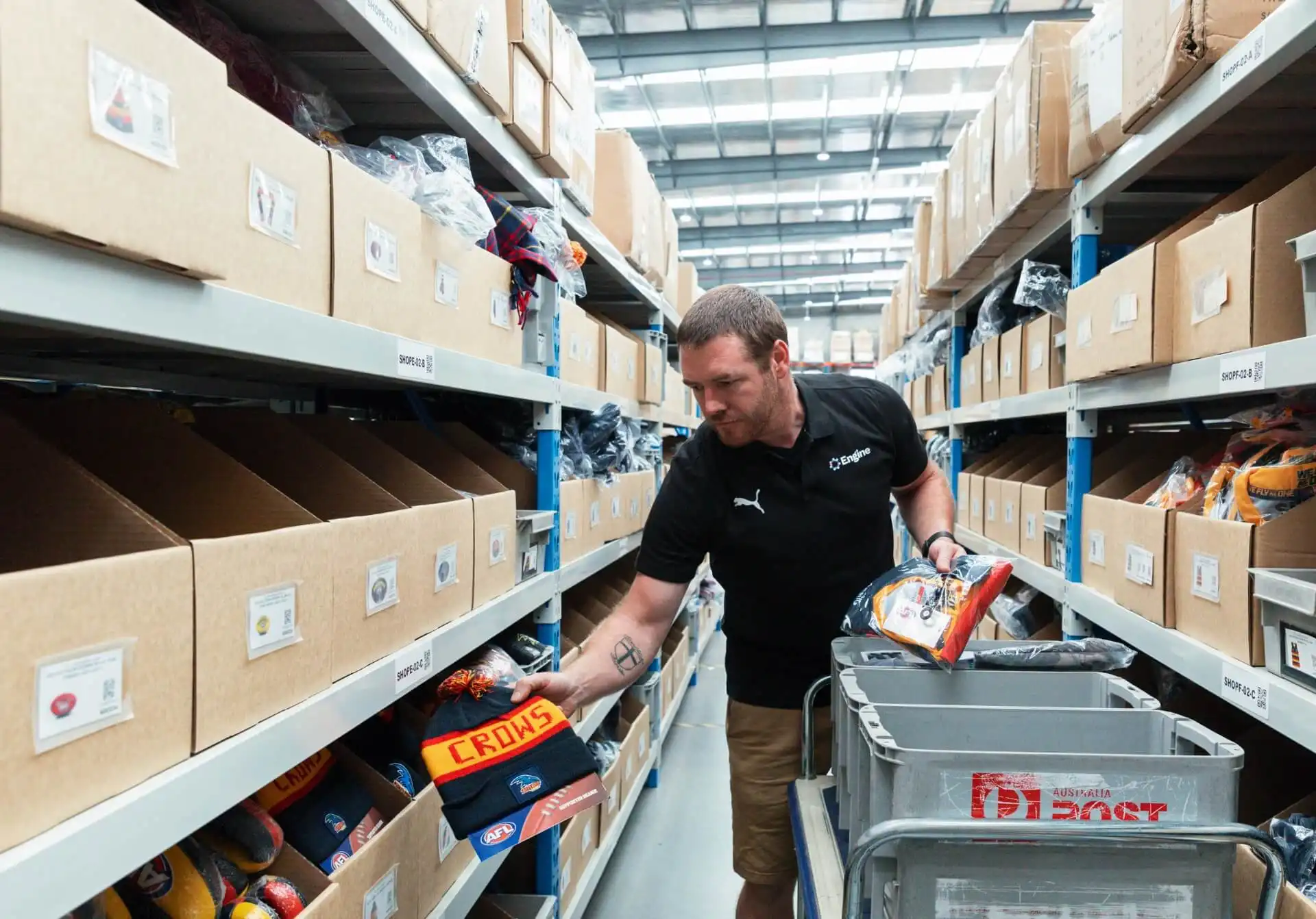 Engine employee storing the products on the warehouse shelves